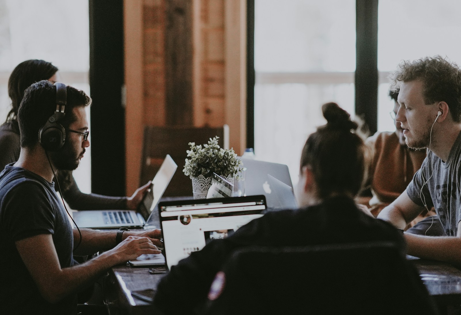 selective focus photography of people sits in front of table inside room, workers' compensatiob