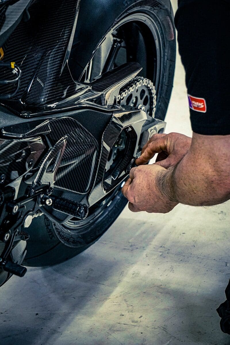 Mechanic working on a motorcycle chain