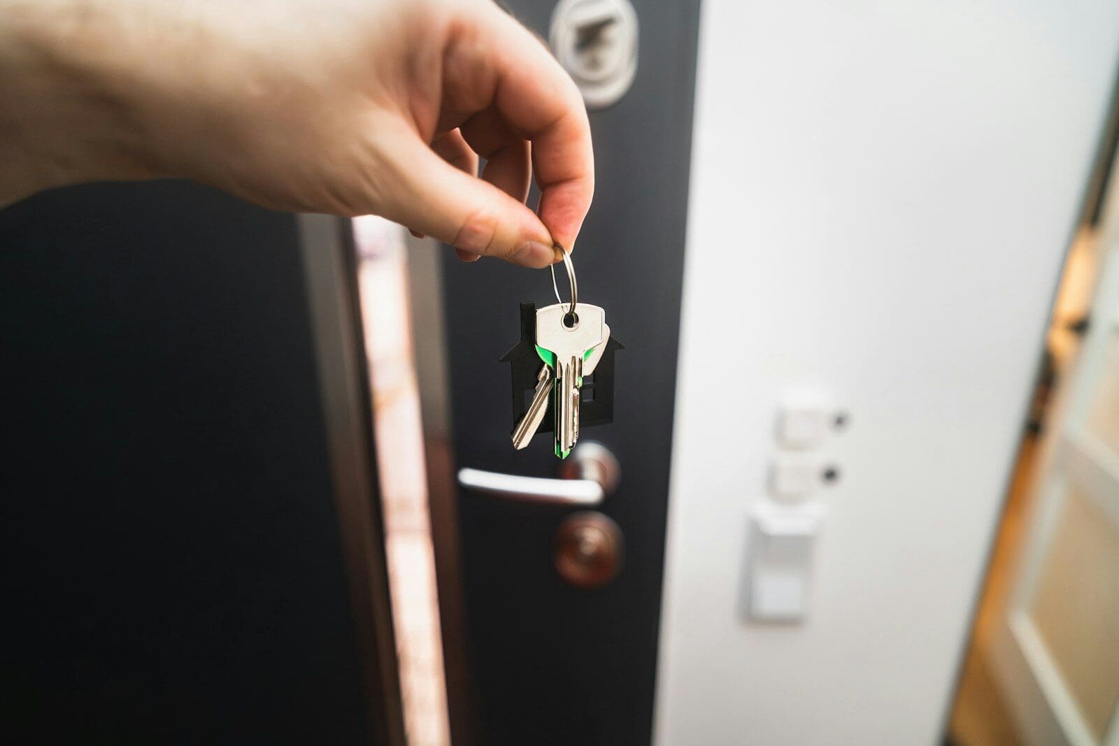A person is holding a key to a door