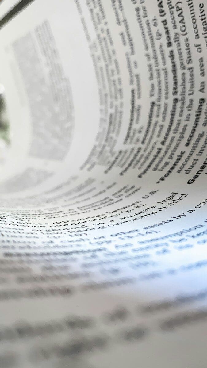 a close up of a book with a pen on top of it